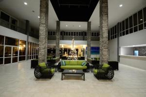 a lobby with a green couch and chairs at Royal St. Kitts Hotel in Frigate Bay