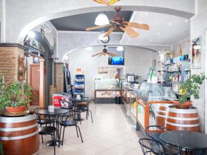 a restaurant with tables and chairs and a ceiling fan at Eraldo Bed and breakfast in Cesarò