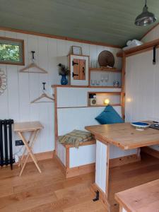 a kitchen with a table and a wooden table at Steam and Stars Luxury Glamping in Williton +35 photos