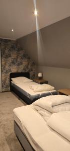 three beds in a room with a brick wall at Rancho U Bodzia in Jeleniów