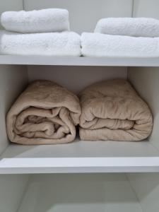 two towels are sitting on a shelf with towels at Mirasoles Suites in Monte Grande +12 photos