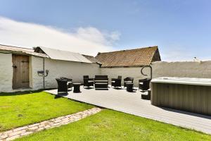 a group of chairs sitting on a deck in a yard at SAUNTON GRANGE 7 Bedrooms in Braunton