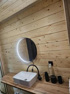 a mirror sitting on top of a wooden wall at Poleska Przystań in Urszulin