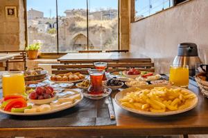a table with many plates of food on it at Zula Cave House in Ürgüp