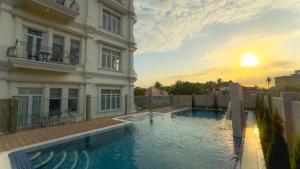 a large swimming pool in front of a building at Chateau Kampot in Kampot