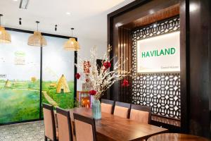 a dining room with a table and a large window at Hoi An Canal House Riverside By Haviland in Hoi An +54 photos
