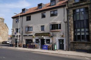 a building on the side of a street at Greyfriars Inn by Greene King Inns in St. Andrews +14 photos
