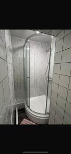 a shower with a glass door in a bathroom at 36 flat 1 - Room 2 in Swansea