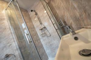 a bathroom with a shower and a sink at Cherish Lewis Hotel Blackpool- 2 min to Beach- Smart Lock- Fast WiFi in Blackpool +75 photos