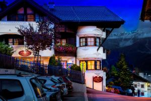 a house with cars parked in front of it at ... mein romantisches Hotel Toalstock in Fiss