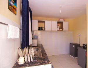 a kitchen with a sink and a counter top at Zariah Homes 1BR Ksm in Kisumu