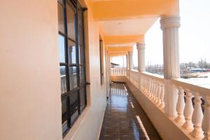 a corridor of a building with columns and windows at Zariah Homes 1BR Ksm in Kisumu