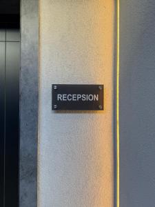a sign on a door with the word reception at Pauz Hotel in Himare
