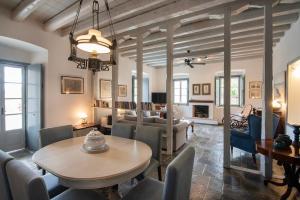 a living room with a table and chairs and a couch at Villa 1853, Spetses in Spetses