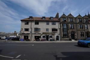 a building on the corner of a street at Greyfriars Inn by Greene King Inns in St. Andrews