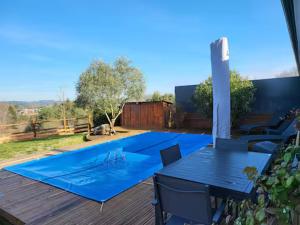 a patio with blue tables and chairs on a deck at Newlook 1 in Trélissac +42 photos