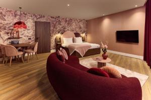 a hotel room with a bed and a couch at Van der Valk Hotel Melle - Osnabrück in Melle +60 photos