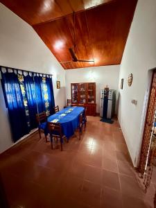 a dining room with a blue table and chairs at Dara Place in Dickwella +14 photos