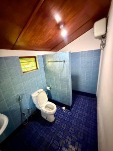 a bathroom with a toilet and a sink at Dara Place in Dickwella
