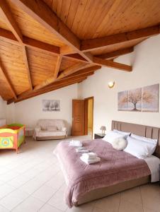 a bedroom with a large bed and a wooden ceiling at Konitsa Horizon Villa in Konitsa