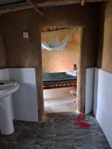 a bathroom with a bed in the middle of a room at Paradise Resort in Chabahinga