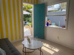 a living room with a table and a window at Casa Mediterrânea Geribá in Búzios