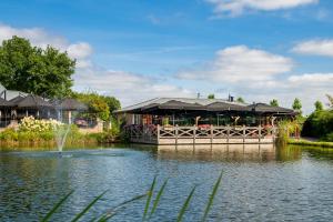 a restaurant on a dock in the middle of a pond at Maashof in Venlo