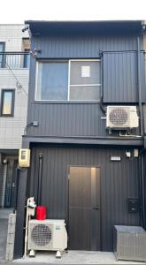 a building with a door and a window at HOTTOSTAYHoNMACHI in Nagoya