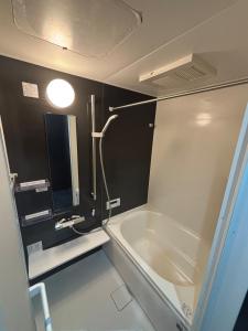 a bathroom with a bath tub and a sink at HOTTOSTAYHoNMACHI in Nagoya +23 photos