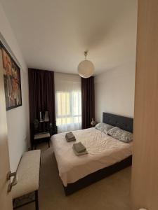 a bedroom with a large bed and a chair at 2 Bedrooms At Caesar Resort & Spa Iskele Claudius 9 in Iskele