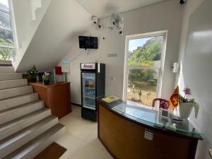a pharmacy lobby with a cash register and stairs at Silina Airport Residence & Transit Hotel in Katunayaka