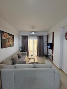 a living room with two couches and a television at 2 Bedrooms At Caesar Resort & Spa Iskele Claudius 9 in Iskele +159 photos