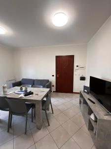 a living room with a table and chairs and a television at La terrazza sul mare in Messina