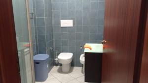 a small bathroom with a toilet and a sink at La terrazza sul mare in Messina