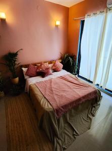 a bedroom with a large bed with pillows on it at Blue Door Homes in Navi Mumbai