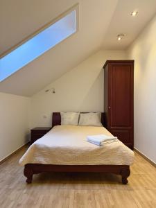 a bedroom with a bed in a attic at Gargždų pramogos in Gargždai