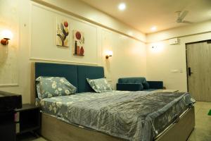 a bedroom with a large bed and a couch at Nova Nest in Jaipur