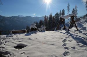 a snow covered mountain with the sun in the background at Ferienhaus Kammerer in Haidberg