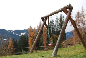 a swing set on a hill in a field at Ferienhaus Kammerer in Haidberg