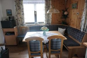 a dining room with a table and a couch at Ferienhaus Kammerer in Haidberg