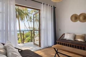 a living room with a couch and a view of the ocean at South Coast Villas by Mandala in Tangalle +81 photos