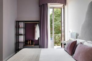 a bedroom with a bed and a large window at Villa Masetta - Luxury Suites in Mondello +34 photos