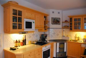 a kitchen with wooden cabinets and a counter top at Ferienhaus Almenblick in Fellbach