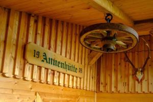 a wooden wall with a light and a sign on it at Annenhütte in Reichenfels