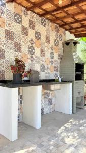 a patio with a table with a pizza oven at Chácara das Mangueiras in Aracaju