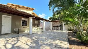 a patio outside of a house with palm trees at Chácara das Mangueiras in Aracaju