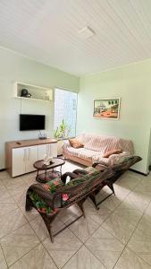 a living room with a couch and a table at Chácara das Mangueiras in Aracaju