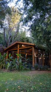 a wooden building with glass windows in a field at Casa Vela Boutique House & SPA in Cascais +155 photos