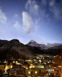 a view of a city with mountains in the background at Zaga Cottage in Kazbegi +11 photos