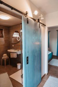 a bathroom with a blue door and a sink at Kultur Weingut Kästenburg in Ratsch an der Weinstraße +58 photos